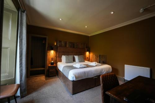 a bedroom with a large bed in a room at The Whisky Vaults in Oban