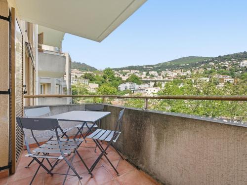 a table and chairs on a balcony with a view at Virginia N214 2P4 in Grasse