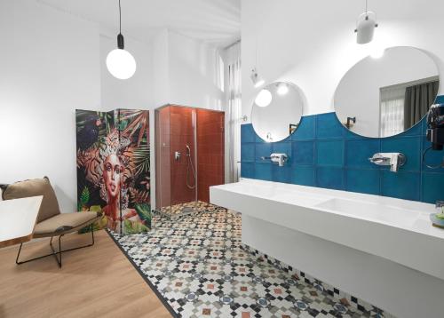 a bathroom with blue and white walls and a shower at The Maroon Bottle Hotel in Thessaloniki