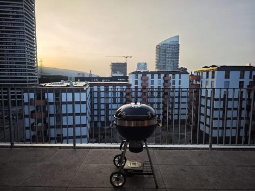 a grill sitting on the roof of a building at Modern Zurich Apt with Balcony View & Workspace in Zurich