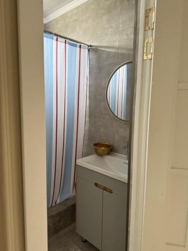 a bathroom with a sink and a mirror at The Bay Apartments in Cholpon-Ata