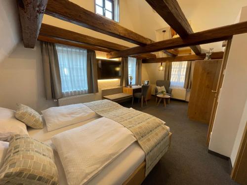 a bedroom with two beds in a room with windows at Gästehaus Klingler in Besigheim