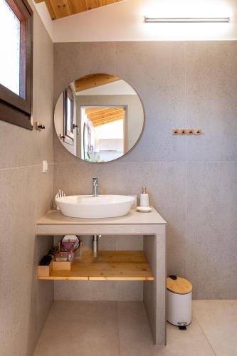 a bathroom with a sink and a mirror at Kallisti Luxury Rooms in Ierissos