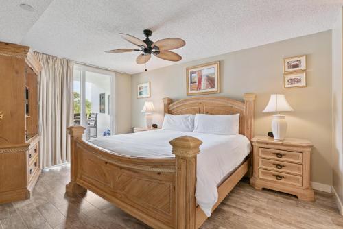 a bedroom with a bed and a ceiling fan at North Breakers - Unit 202, Wood Ave in East End