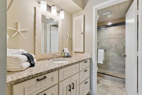 a bathroom with a sink and a shower at North Breakers - Unit 202, Wood Ave in East End