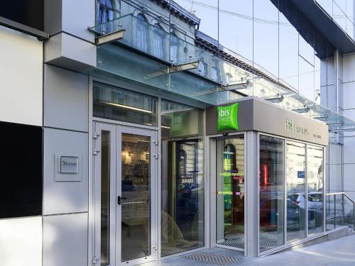 a store front with glass doors in front of a building at Ibis Styles Lviv Center in Lviv