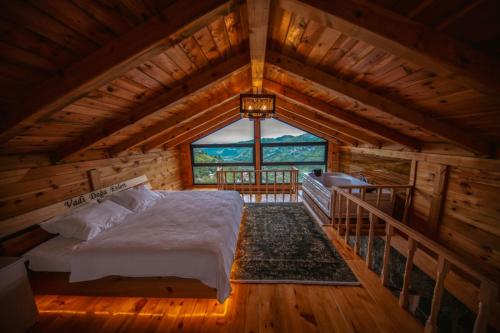 a bedroom in a log cabin with a bed at Vadi Ahşap Doğa Evleri in Ardeşen