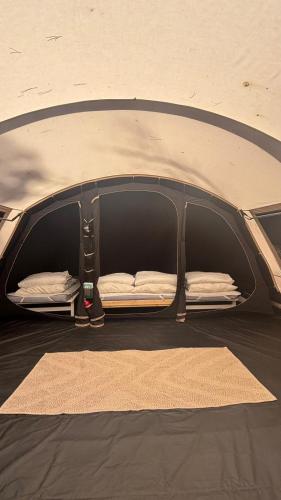 a tent with a bed in the back of it at Bella Tents - Camping Vibes in Marina di Grosseto