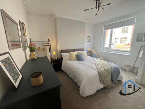 a bedroom with a large bed and a window at 28 Victoria Terrace, Bedlington, ground floor in Bedlington