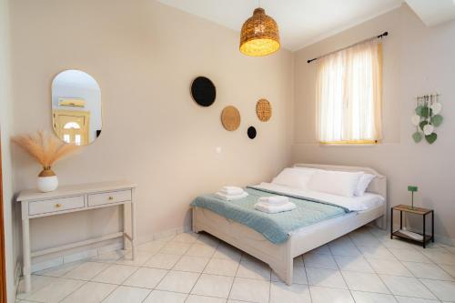 a bedroom with a bed and a table and a mirror at Nesto Living in Chóra