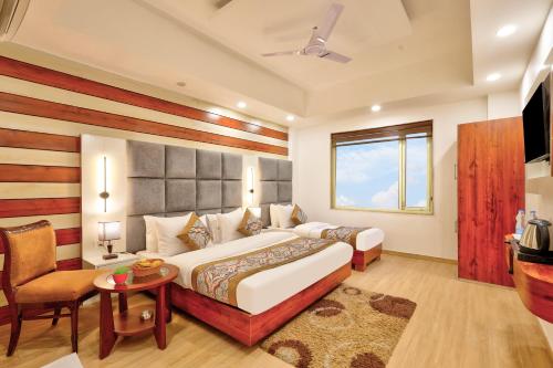 a bedroom with a bed and a table and a chair at Hotel Vedas Heritage - Karol Bagh - Newly Renovated in New Delhi