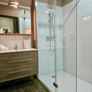 a bathroom with a glass shower and a sink at Hôtel de Charme By Arts & Millésimes in Essoyes