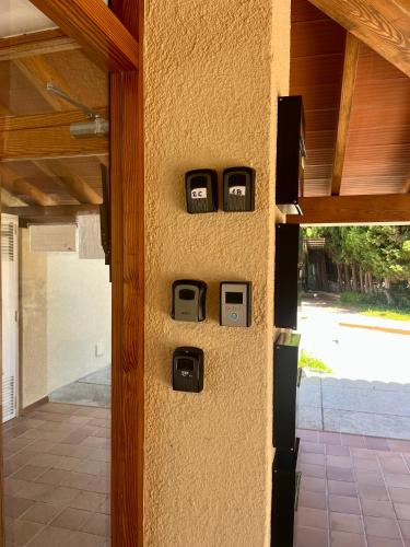 a wall with three toasters on the side of a house at Apartamento Portobello in Port de Pollensa