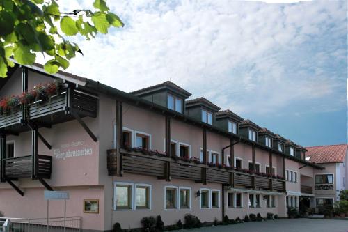 a building with balconies on the side of it at Hotel Vierjahreszeiten in Breitengüßbach