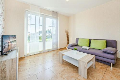 a living room with a couch and a table at Ferienwohnung Sonneneck in Kachlin
