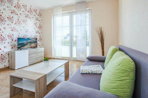 a living room with a couch and a table at Ferienwohnung Sonneneck in Kachlin
