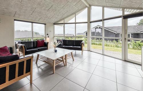 a living room with couches and a table at Nice Home In Haderslev With Sauna in Haderslev