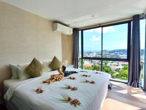 a bedroom with a large bed with flowers on it at Baan Saint-Tropez Seaview Villas Kata Beach in Kata Beach