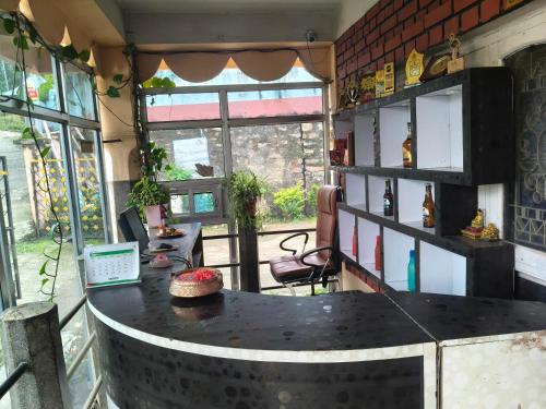 a room with a table with a laptop on it at Ilam Pahuna Ghar in Ilām