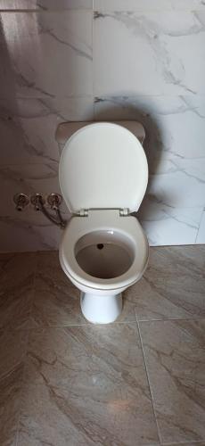 a bathroom with a white toilet in a room at Viva La Vida Beach Camp in Nuweiba