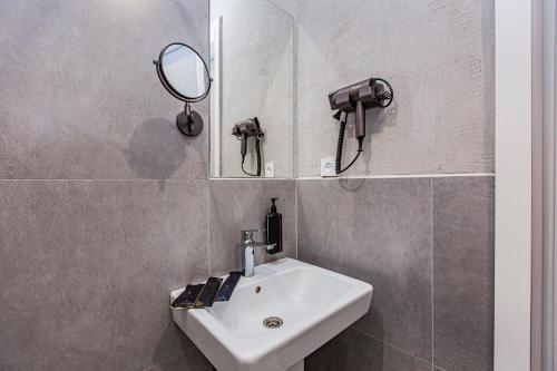 a bathroom with a sink and a mirror at TAU 28 Hotel in Almaty