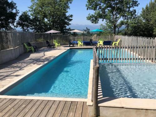 a small swimming pool with a wooden deck and chairs at Camping 2 étoiles - Piscine - ccbgcid in Belloc