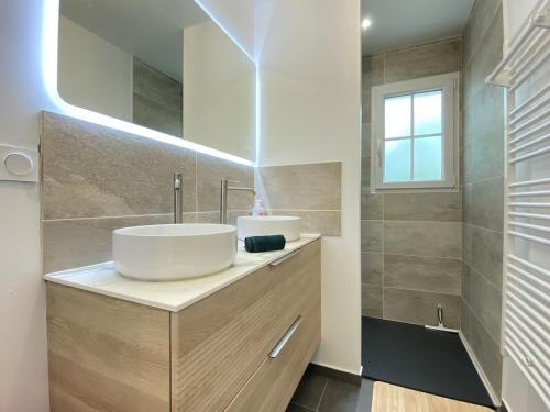 a bathroom with a sink and a mirror at La Maison Moderne - 6 pers - SPA - Piscine in Saint-Sauveur-dʼAunis