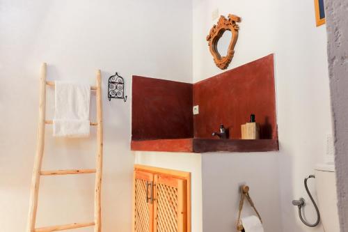 a bathroom with a wooden shelf above a door at Ifni Sunset in Sidi Ifni