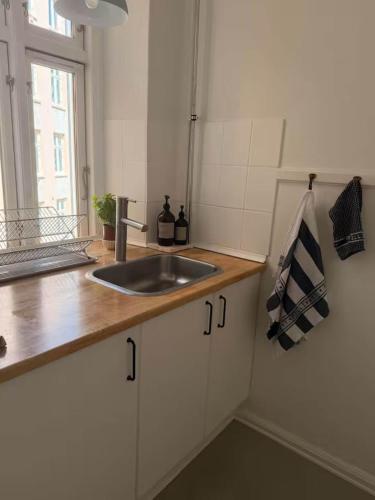 a kitchen counter with a sink and a window at Hearthstone Atelier in Antwerp