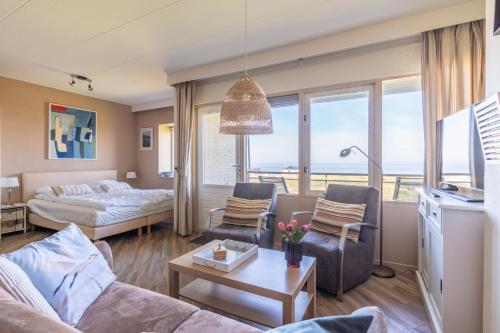 a living room with a couch and a bed at Appartementencomplex Juliana 158 in De Koog