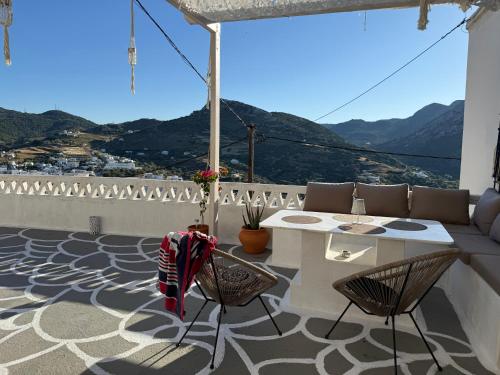a patio with a table and chairs on a balcony at Vasiliki Skyros Castle View in Skiros