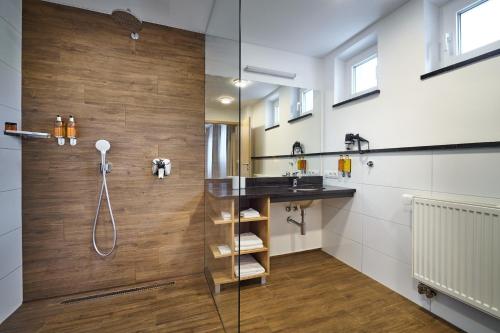 a bathroom with a shower and a sink at Hotel Urpín City in Banská Bystrica