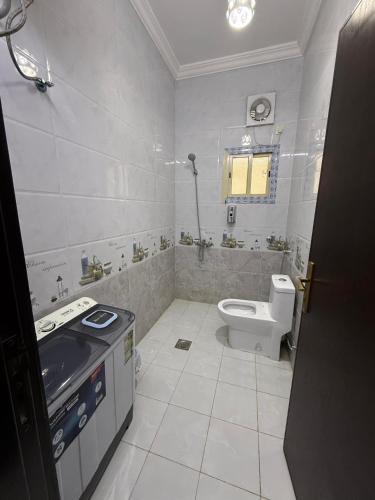 a white bathroom with a toilet and a sink at اطلال الهدا Al-Hada ruins in Taif