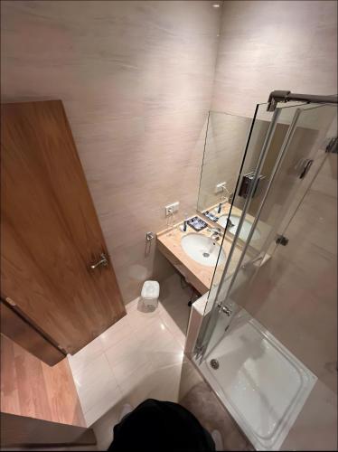 a bathroom with a shower and a sink at Comillas 30 Primera Línea de Playa in Comillas