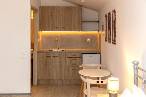 a small kitchen with a sink and a table at Nataly's Gardens with Pool Lagonissi in Lagonissi