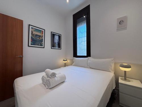 a bedroom with two beds with towels on them at Private Terrace House near Camp Nou in Hospitalet de Llobregat