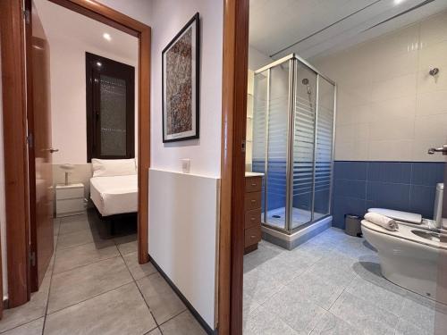 a bathroom with a shower and a toilet and a sink at Private Terrace House near Camp Nou in Hospitalet de Llobregat