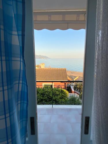 a view of the ocean from a door at Glyfada Corfu Apartment in Glyfada