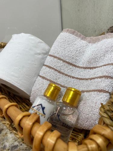 a basket with two bottles of water and a towel at Pousada Casa Grande in Barra do Garças