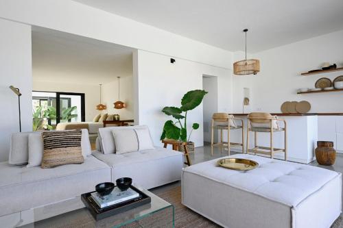 a living room with two white couches and a table at Casa Abora - Ocean Views, Private Pool & Sunsets in La Pared