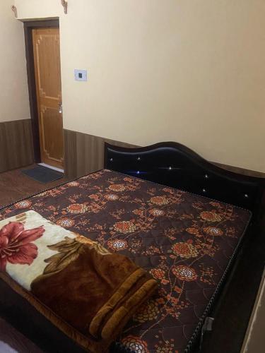 a bed with a blanket on top of it at Ahmed Lodge in Harganyiwan
