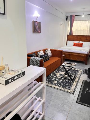 a living room with a couch and a bed at Casa Stays in Kiambu