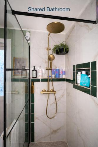 a bathroom with a shower with a glass door at Tiny House - The LOWFO House Lofoten in Moskenes