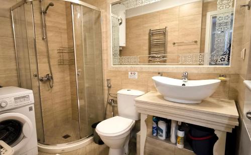 a bathroom with a sink and a toilet and a shower at Harmony Suites apartment 4 floor in Sunny Beach