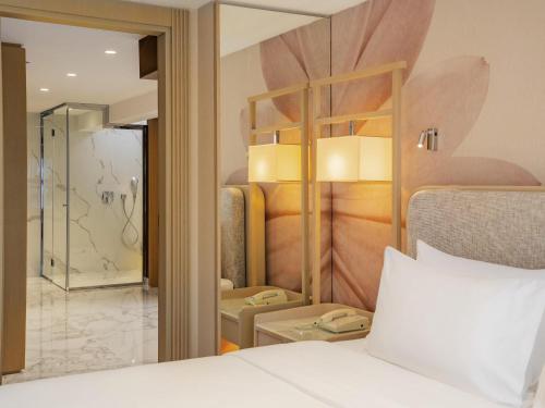 a hotel room with a bed and a bathroom at Mövenpick Hotel Istanbul Bosphorus in Istanbul
