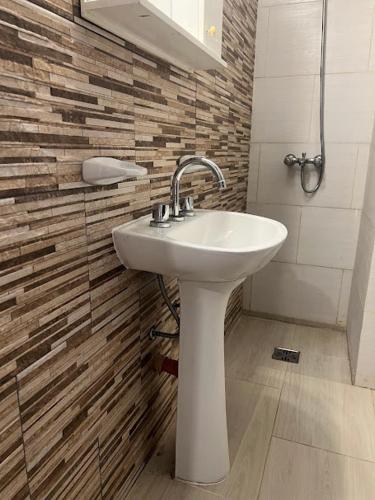 a bathroom with a white sink and a mirror at Espacio493 in Villa Gesell