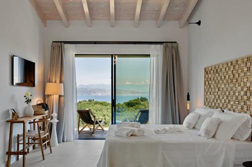 a bedroom with a bed with a view of the ocean at Villa Orama Corfu in Karyótikon