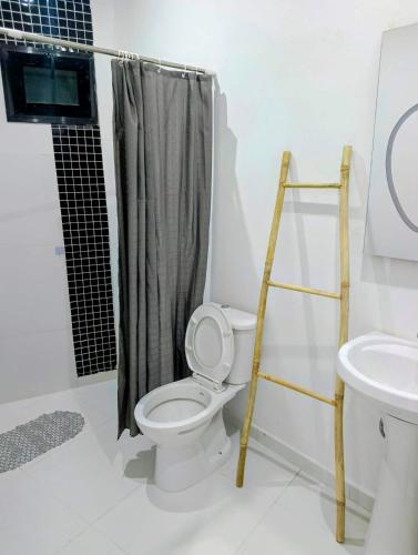 a bathroom with a toilet and a shower and a ladder at Izuba APPART' HÔTEL in Ngaparou