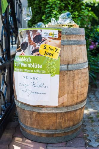 a wine barrel with a sign on it at Pension Julia & Haus Elisabeth - Wallner's Hofheuriger & Weinhof in Mörbisch am See