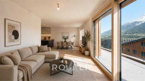 a living room with a couch and a large window at Panorama Apartment Ried-Brig in Ried-Brig